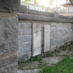 Stuart Lair with plaques mounted in Kingston's Lower Burial Ground